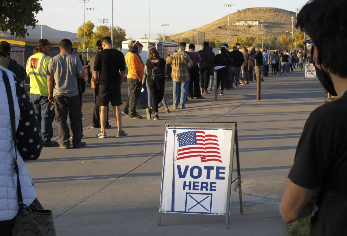 People wait to vote in-person at Reed High School in Sparks, Nev., prior to polls closing on Nov. 3, 2020 (AP Photo/Scott Sonner, File)